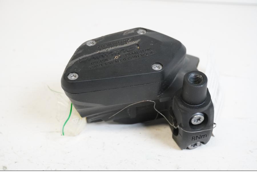 Baksidan på <p>Bromshuvudcylinder fram från BMW R 1200 GS 2013.</p>
<p>Utan brytare, skrapat lock.</p> motorcykel.