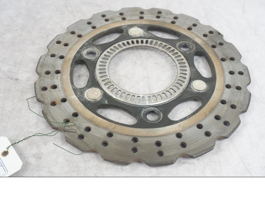 Framsidan på Bromsskiva från en Kawasaki Ninja 300 -2014 motorcykel.