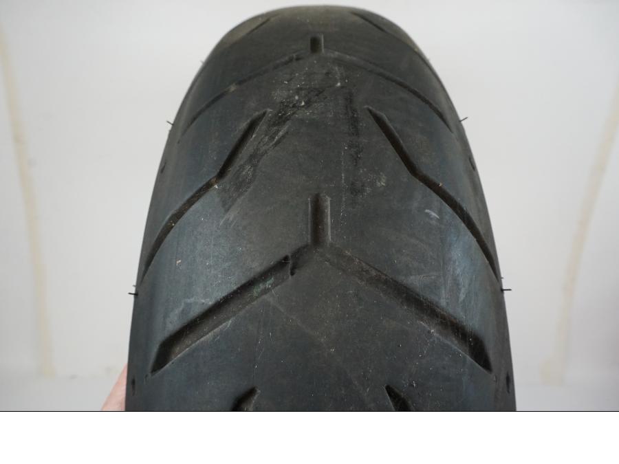 Baksidan på <p>Däck: Dunlop D407T Harley Davidson.</p>

<p>Dimension: 180/65B16 M/C 81H.</p>

<p>Tillv. 4817.</p>

<p>Mönsterdjup: ca. 40 %, plattslitet och torrsprickor finns.</p> motorcykel.