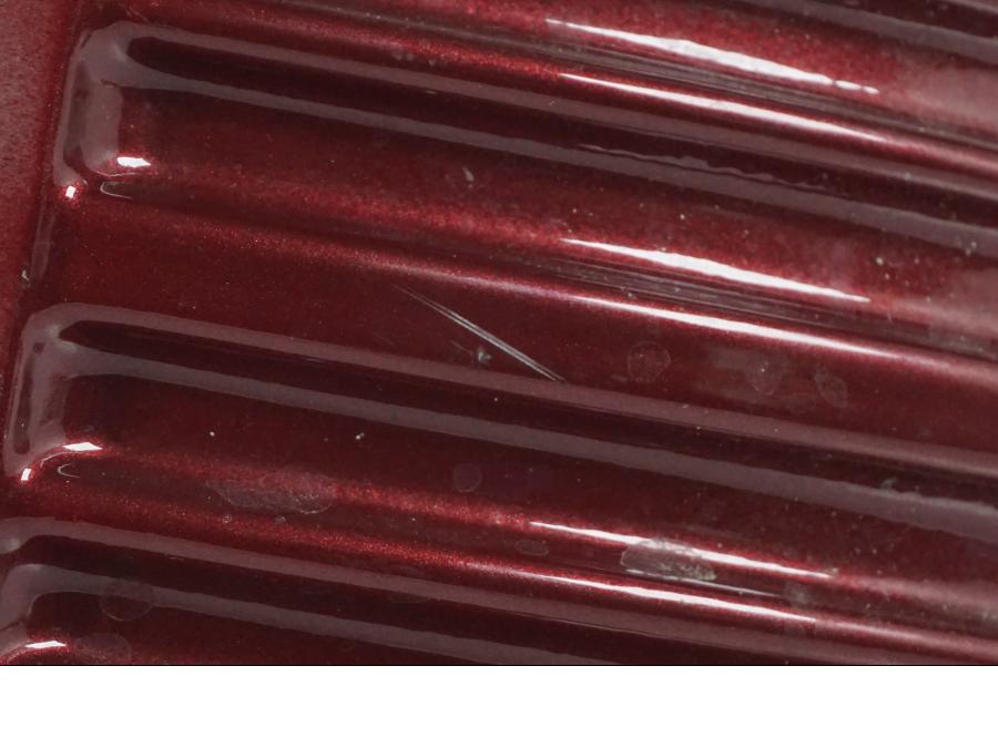 Vänster sida på Oljetank från en H-D Softail FXCW Rocker -2008 motorcykel.