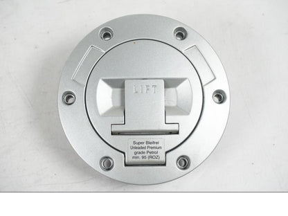 Snett nerifrån på <p>Låssats från BMW R 1200 RT 2011.</p>

<p>2st nycklar och 1st plastnyckel, tändningslås, förvaringfackslås, sadellås och tanklock.</p> motorcykel.