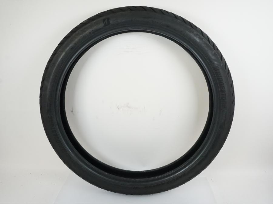 Framsidan på <p>Däck: Bridgestone Battlax Adventure A41.</p>

<p>Dimension: 90/90-V21 M/C (54V).</p>

<p>Tillv. 3721.</p>

<p>Mönsterdjup: ca. 80 %.</p> motorcykel.