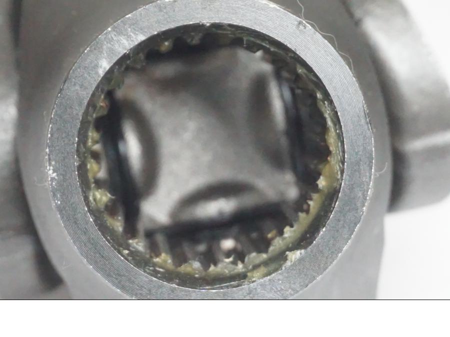 Snett nerifrån på <p>Kardanaxel från Triumph Tiger Explorer 2010.</p>

<p>Med låsring.</p> motorcykel.