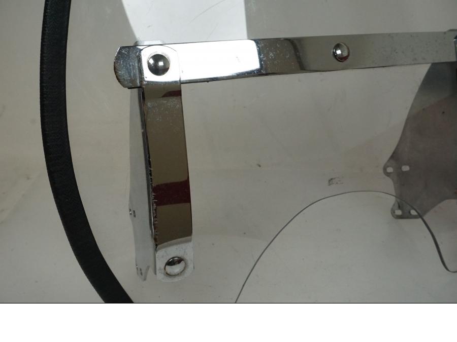 Snett uppifrån på <p>Vindruta från Suzuki VZ 800 2000.</p>

<p>Fästen finns ej, skrapmärke på kromdetalj se bilder, rutfästena är original men vindrutan är hemmagjord. Ytliga repor finns på rutan se bilder.</p> motorcykel.