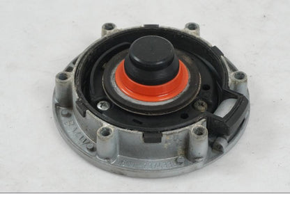 Snett nerifrån på <p>Låssats från BMW K 1200 R Sport 2007.</p>

<p>1st nyckel och en plastkopia, sadellås, tanklock, tändningslås (saknas plastbit vid en av kontakterna).</p> motorcykel.