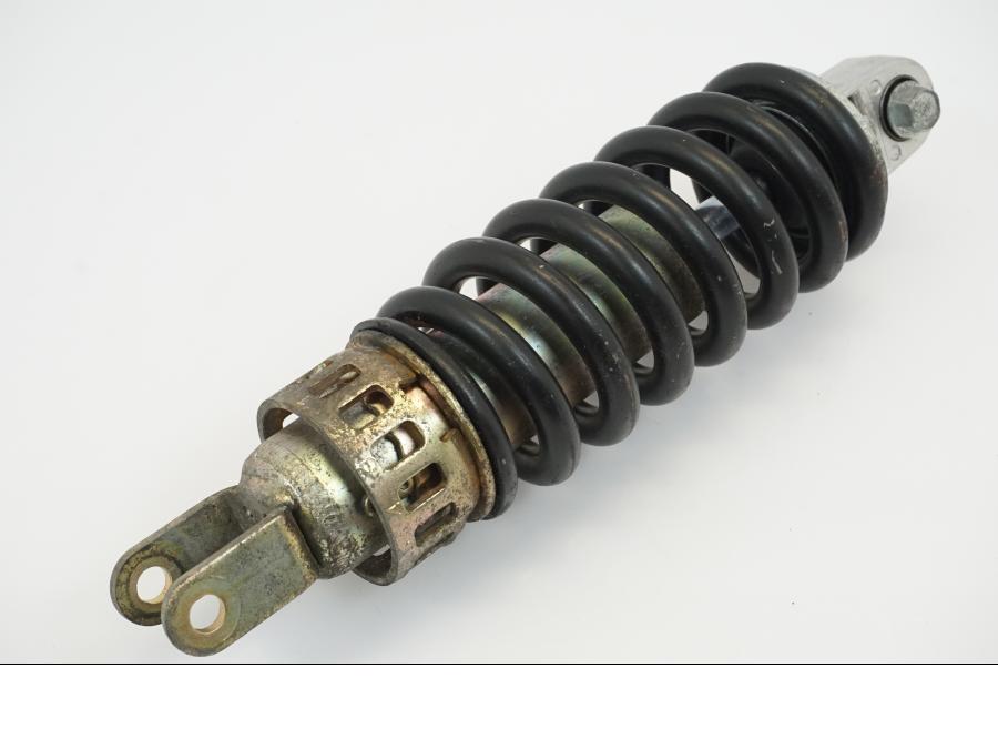 Baksidan på <p>Stötdämpare från Suzuki GSX-R 600 Corona 2000.</p>

<p>Okej skick, justerbar. C/C mått: ca 300mm.</p> motorcykel.